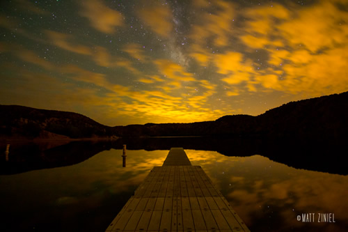 Milky Way through the clouds over Santa Cruz Lake in New Mexico